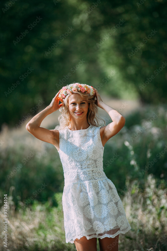 portrait of a beautiful sexy smiling girl with a wreath on his head in the spring park portrait of a beautiful sexy smiling girl with a wreath on his head in the spring park