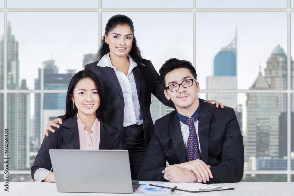Confident multi ethnic business team in the office Confident multi ethnic business team in the office