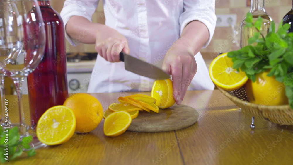 woman cutting slices of orange slow motion