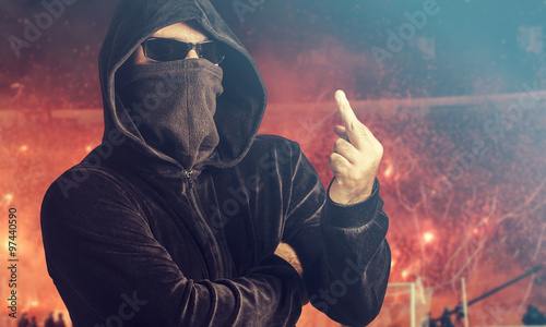 Angry hooligan showing the middle finger