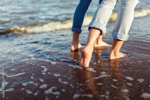 feet of couple woman and man in the sea waves © toxicoz