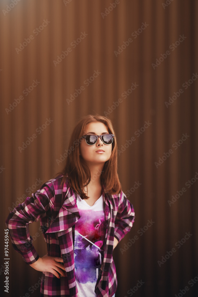 Obraz premium Fashion portrait of pretty young hipster woman in glasses