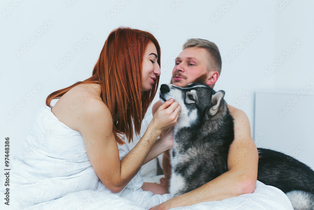 Young adult couple lying on bed Young adult couple lying on bed