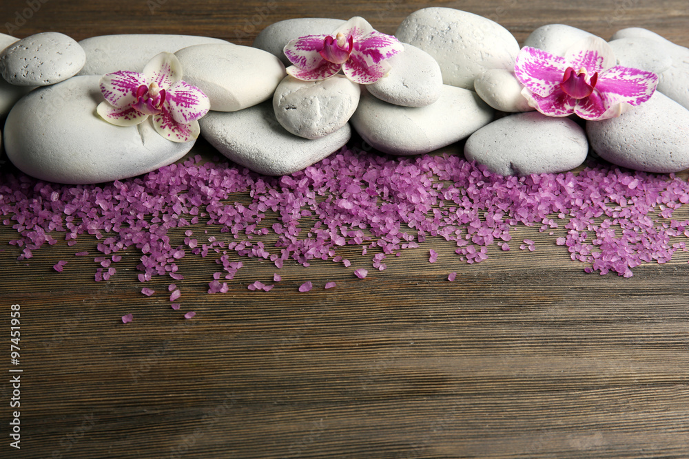 Spa stones and orchid on wooden background Spa stones and orchid on wooden background
