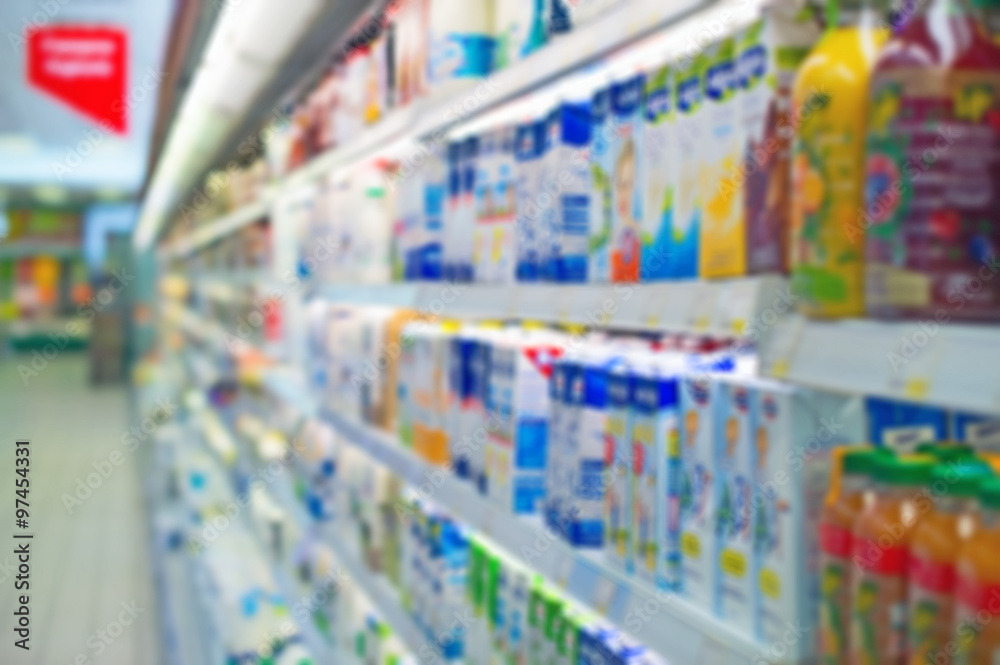 Blurred shelves with milk products in the store. Suitable for background.