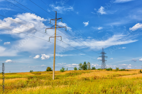 High voltage line and cloudy sky