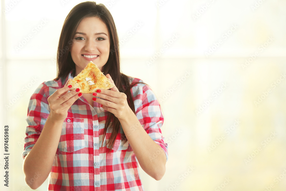 Beautiful girl eating tasty pizza on light background Beautiful girl eating tasty pizza on light background