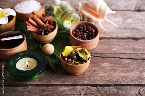 Beautiful spa setting on palm leaf on wooden table