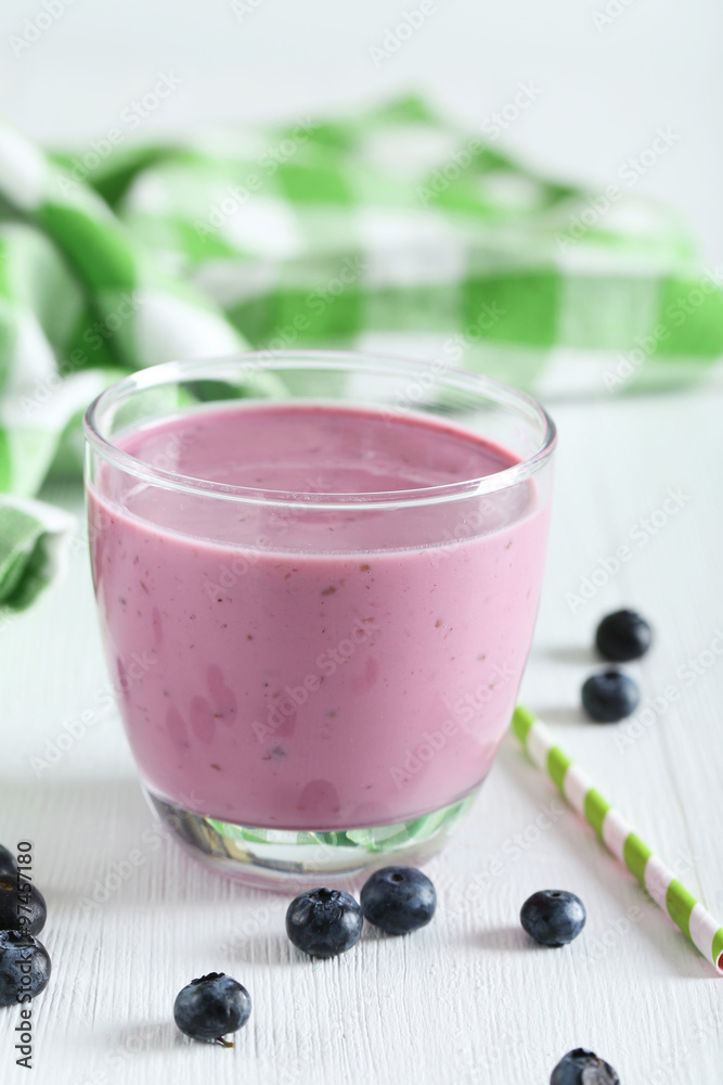 Fresh blueberry smoothie in the glass on white wooden background Fresh blueberry smoothie in the glass on white wooden background