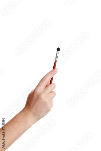 Female hand with brush for make-up isolated on white