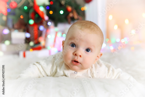 Cute baby near fireplace an...