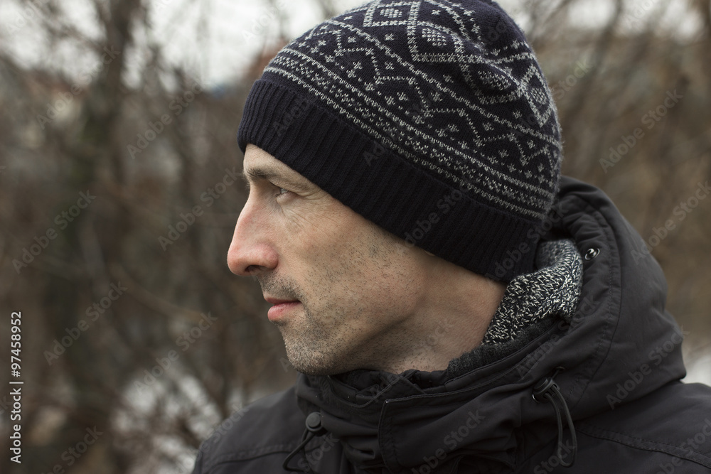A man in a knitted cap and a black jacket A man in a knitted cap and a black jacket