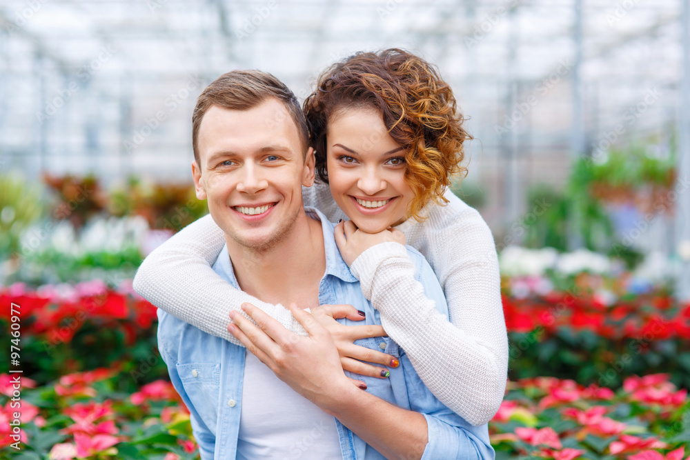 Fototapeta premium Young couple in the greenhouse.