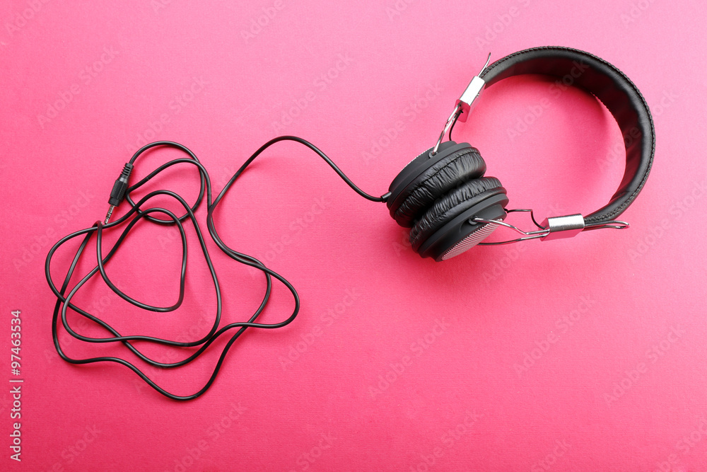Black headphones on pink background Black headphones on pink background