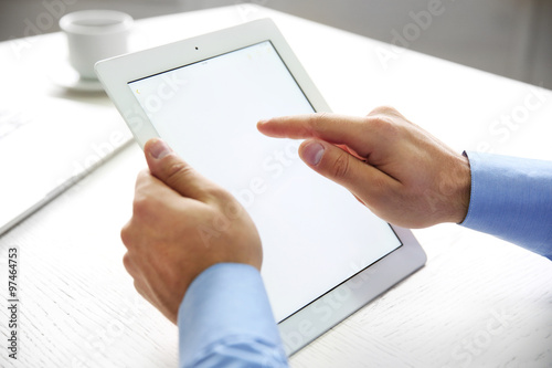 Young businessman using his tablet-pc, close up