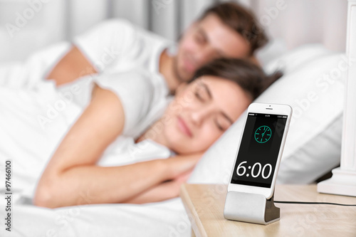 Happy couple waking up with...