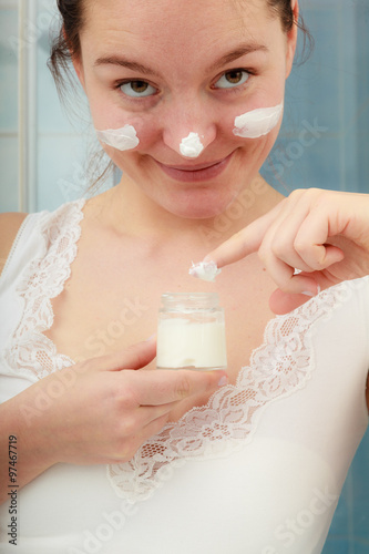 Woman applying moisturizing skin cream. Skincare.