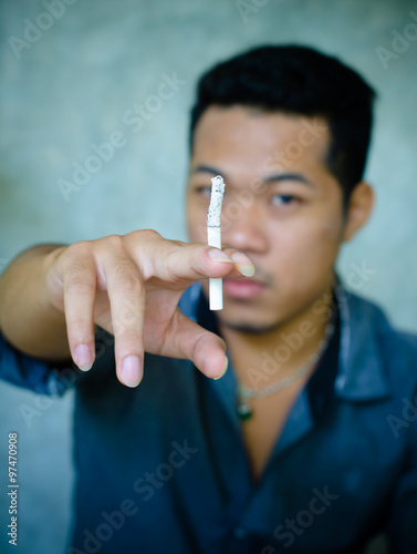 a young man smoking a cigarette