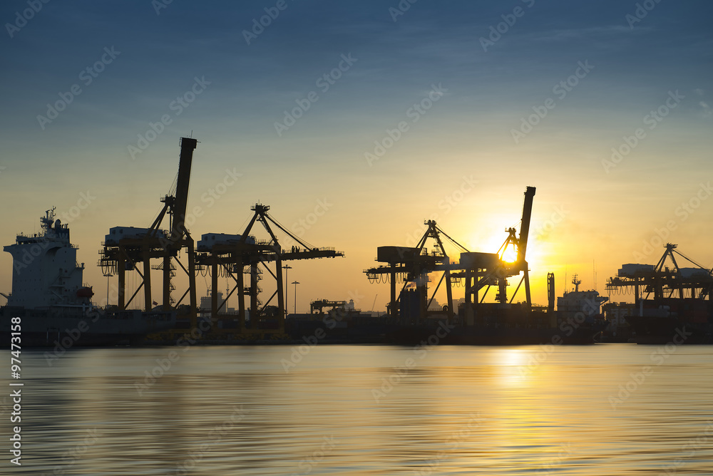 silhouette of Container Cargo freight ship with working crane br