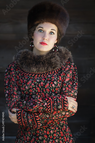 Russian beauty in traditional medieval style clothing with crossed arms photo