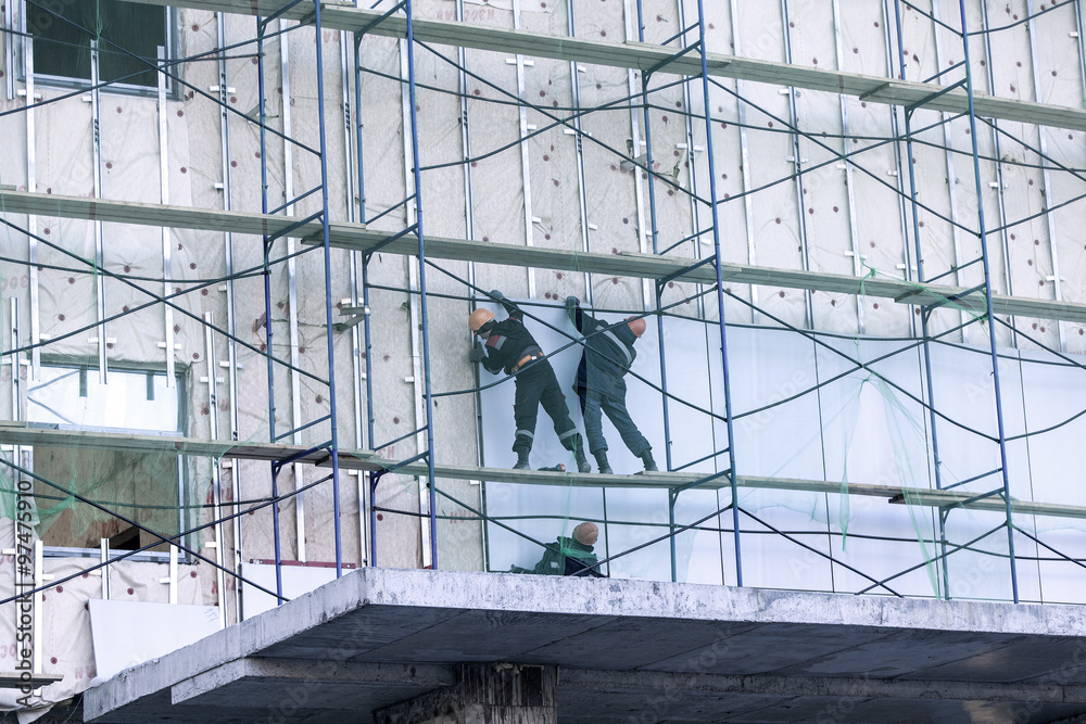 Naklejka premium three builders build the house