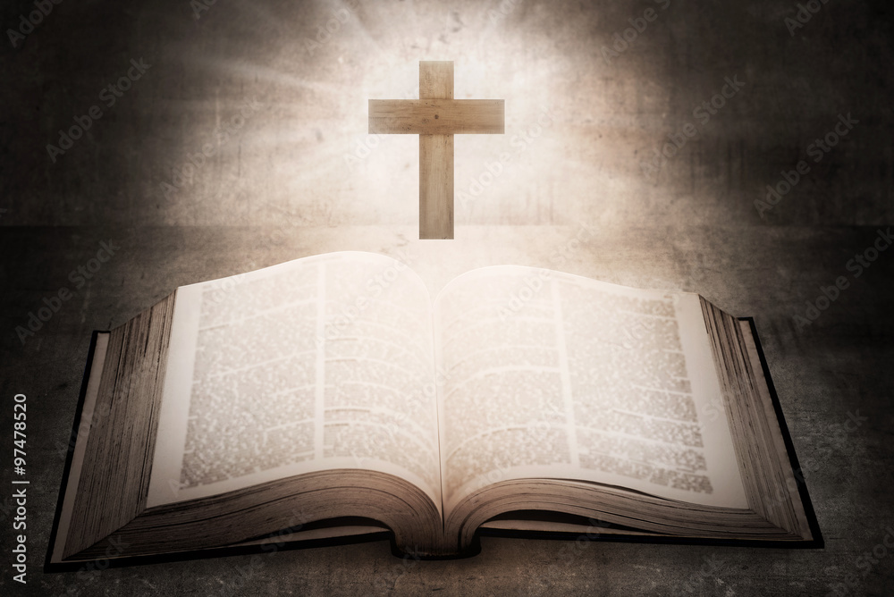Open holy bible with wooden cross in the middle Open holy bible with wooden cross in the middle