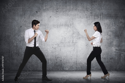 Business man and woman fighting