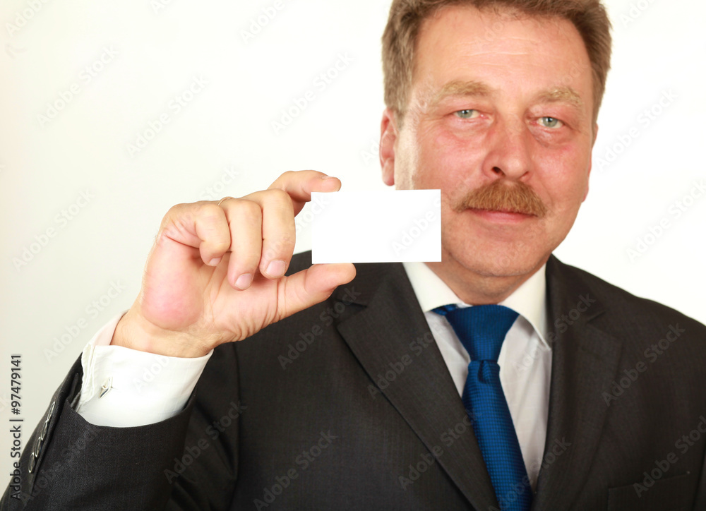 Man's hand showing business card - closeup shot on grey background Man's hand showing business card - closeup shot on grey background