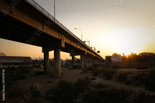 Quadro su tela silhouette sunset of Friendship Bridge Thailand - Myanmar over Moei River at Mae