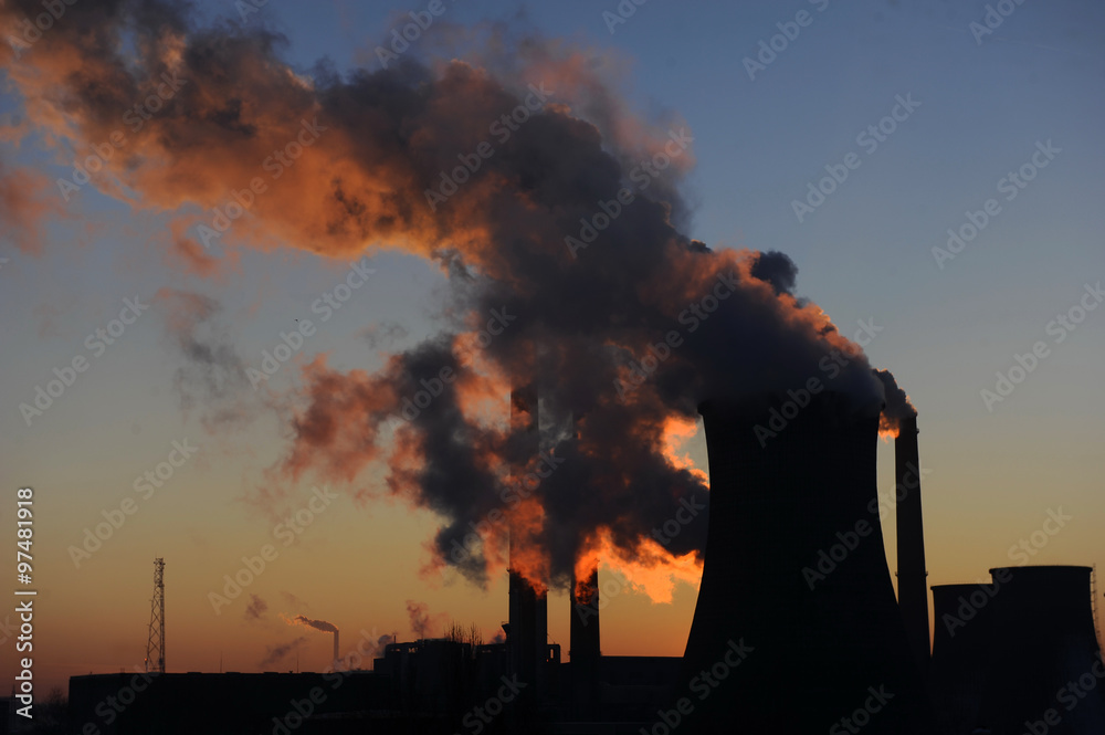Hot steam coming from industrial chimney of heating plant 

