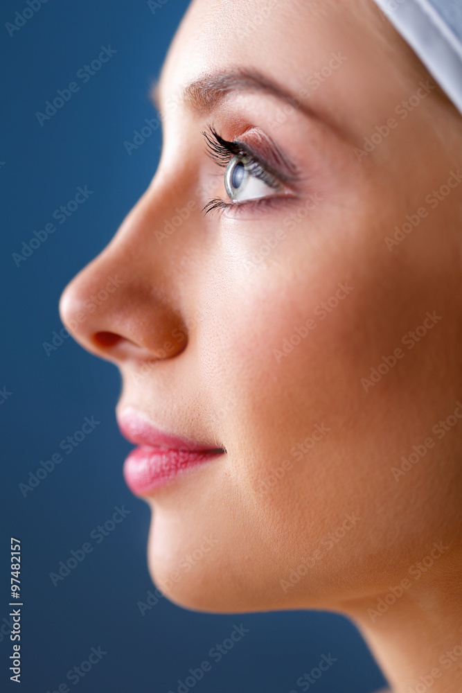 A beautiful woman, portrait isolated on blue background A beautiful woman, portrait isolated on blue background