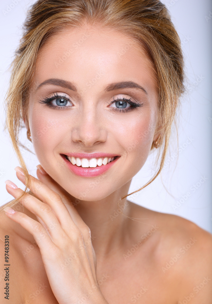 Young woman touching her face isolated on white background Young woman touching her face isolated on white background
