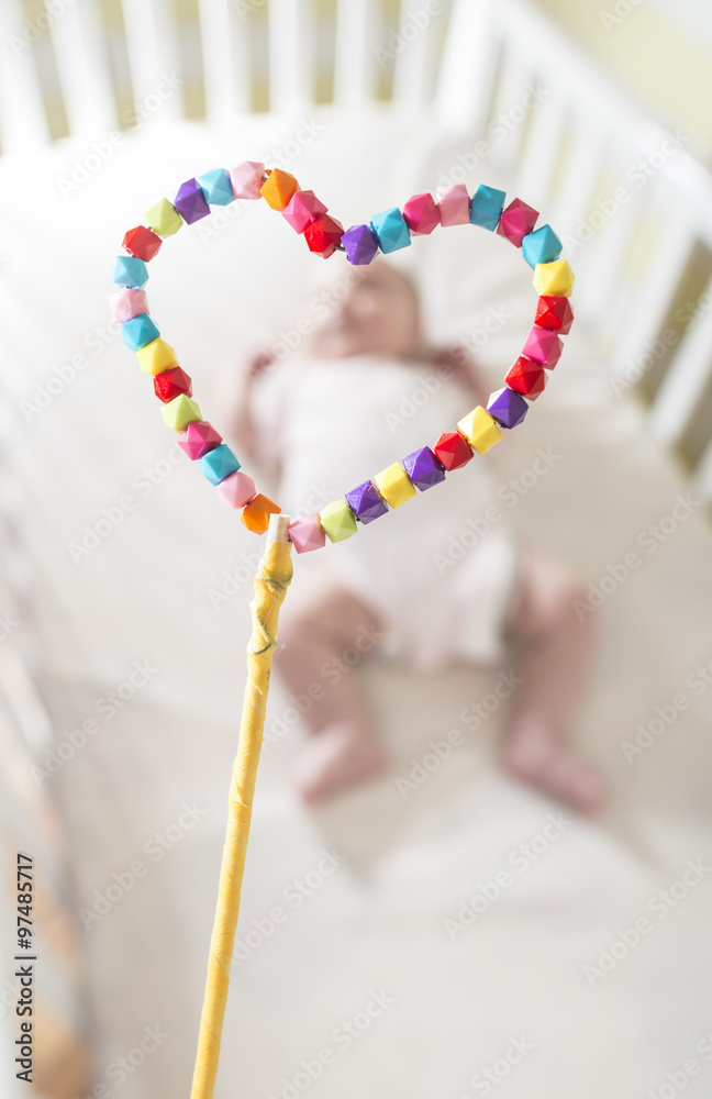 Baby in a bed in frame of heart shape