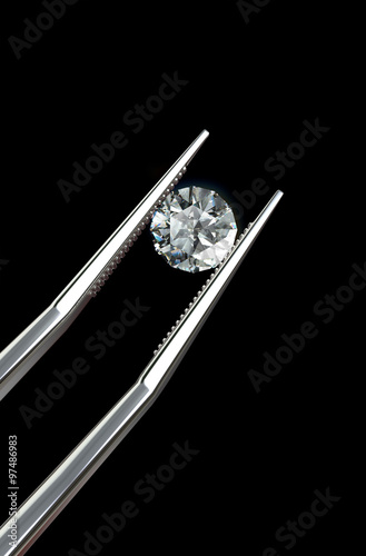 Luxury diamond in tweezers closeup