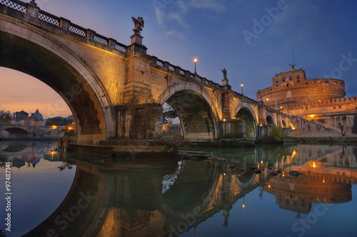 Fototapeta Rome. Image of the Castle of Holy Angel and Holy Angel Bridge over the Tiber River in Rome at sunset.