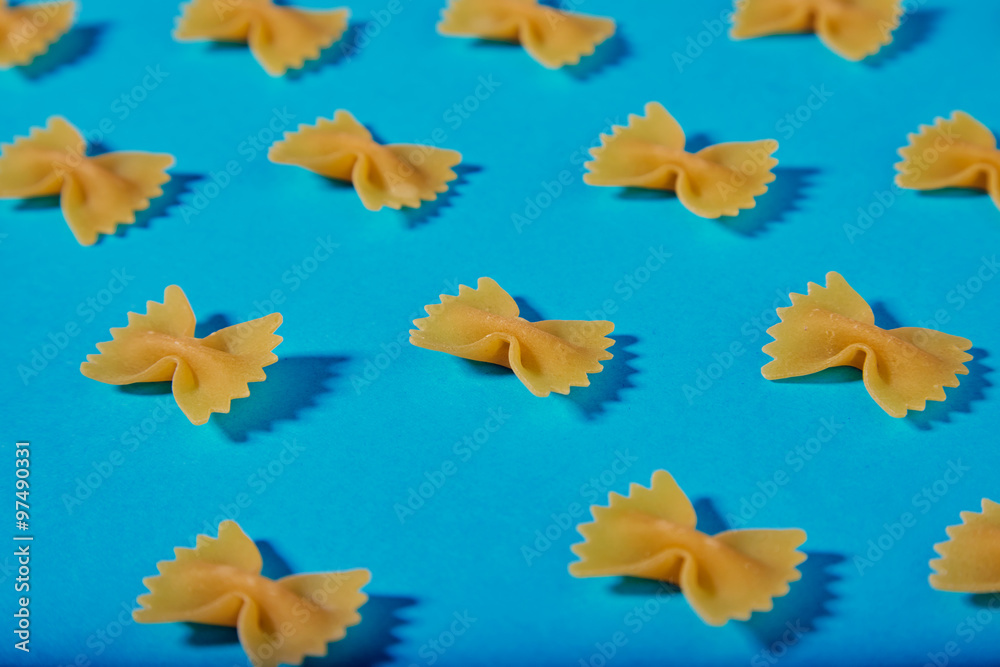 Fototapeta premium italian Farfale pasta pattern on turquoise background closeup