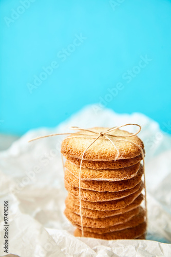 Column of tasty cookies tied with rope for gift on turquose back