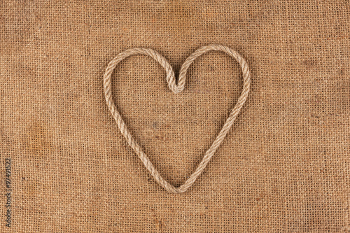 Conceptual image of the heart made in rope lying on sackcloth