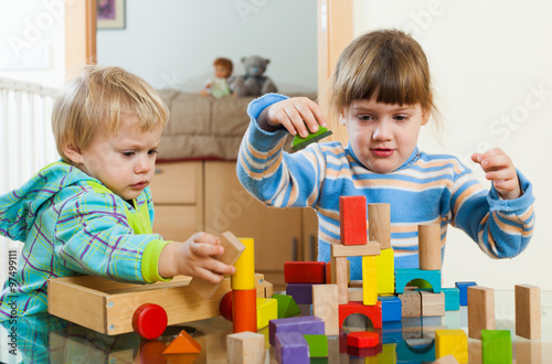 Two children playing with blocks