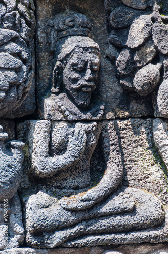 Meditating and sitting Stone carving at buddhist temple Borobudur photo