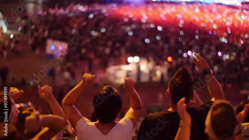 Handheld shot of a crowd making party at a rock concert. Slow motion
