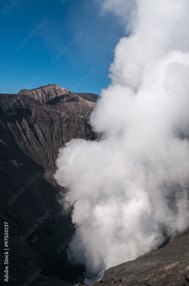 Volcano Bromo Errupting sulfur Smoke in the blue sky