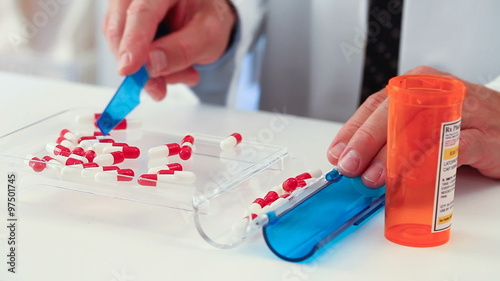 Pharmacy: Man Counting Capsules In Tray