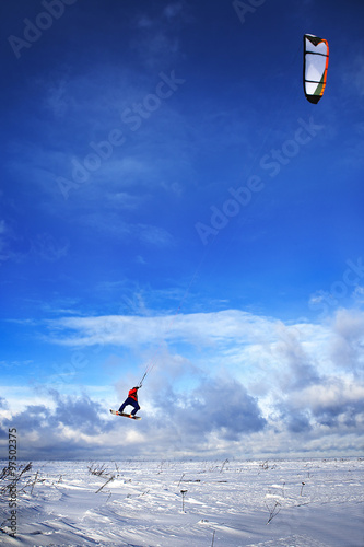 snowkiting man jumps on board to sky