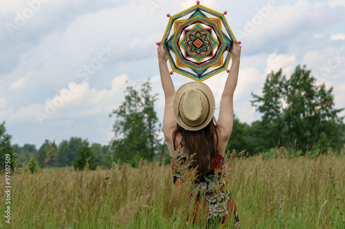 Girl holds over the head of a mandala