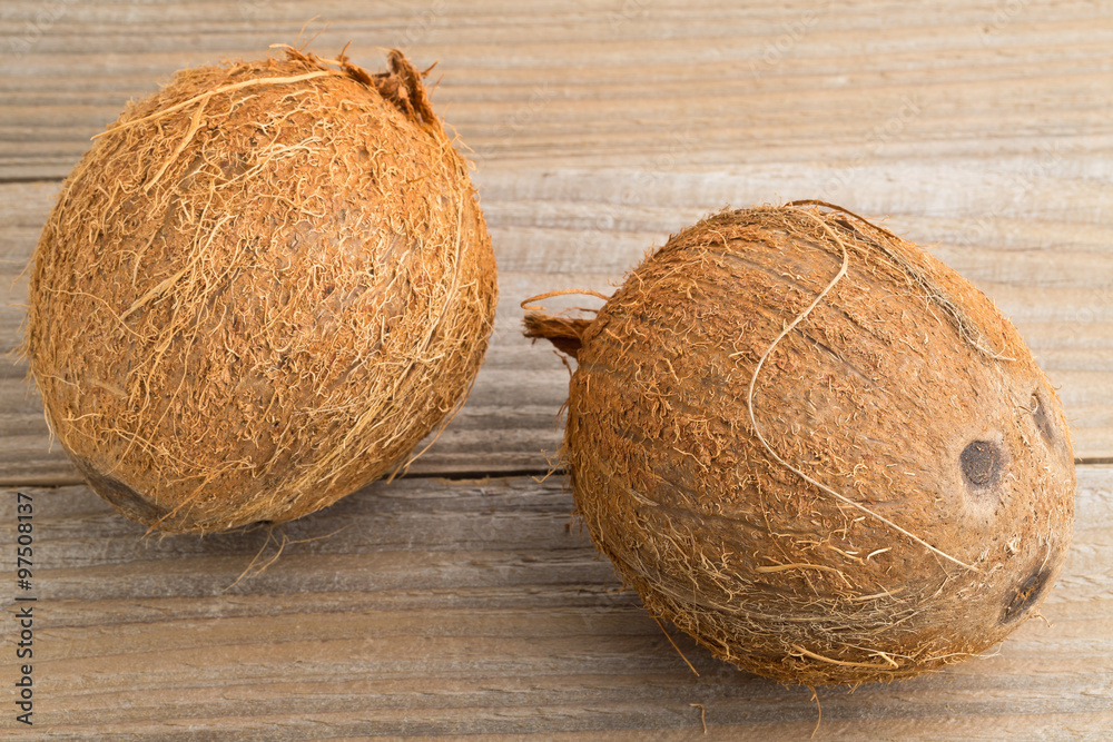 Whole coconuts on table Whole coconuts on table