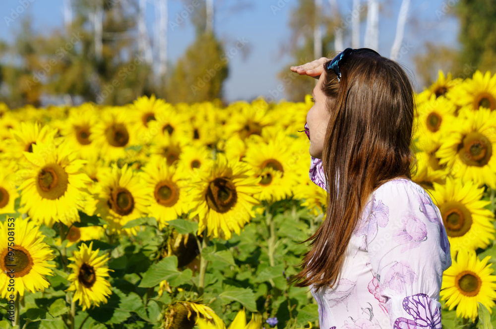 Woman looking for someone in the field of sunflowers Woman looking for someone in the field of sunflowers