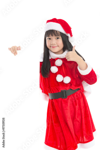 Little asian girl in in Santa Claus uniform with an empty bann