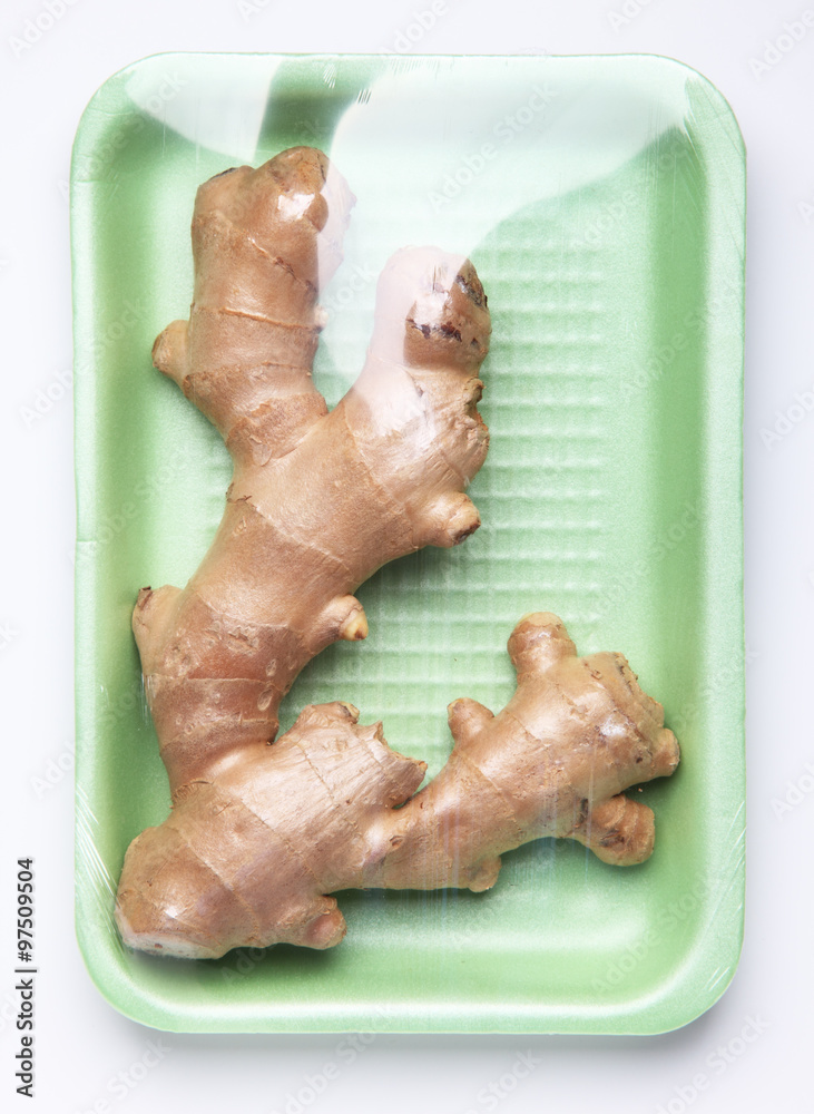 Fototapeta premium Image of plastic pack of ginger root from store on white backgro