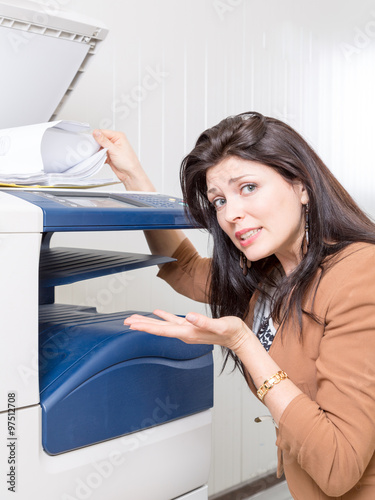 sad unhappy woman in office with copier printer